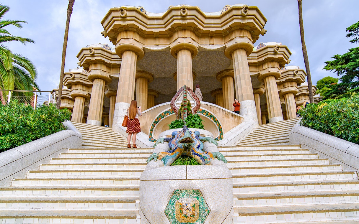 Tourist at the dragon staircase of Park Güell, Barcelona.