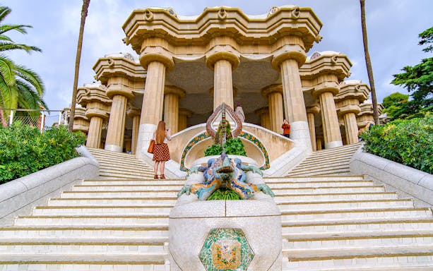 Tourist at the dragon staircase of Park Güell, Barcelona.