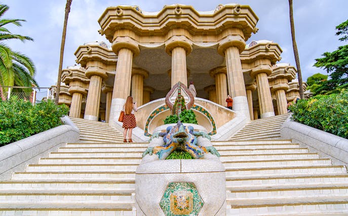 Tourist at the dragon staircase of Park Güell, Barcelona.