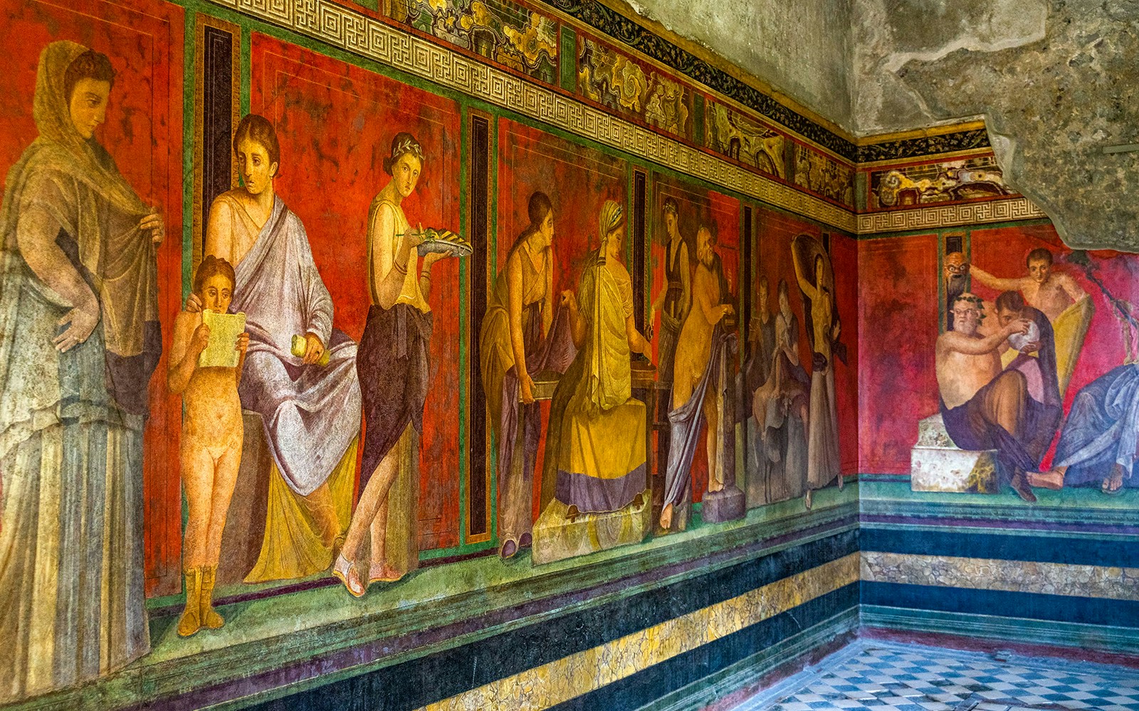 Ancient frescoes depicting figures in the Villa of the Mysteries, Pompeii.