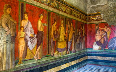 Ancient frescoes depicting figures in the Villa of the Mysteries, Pompeii.