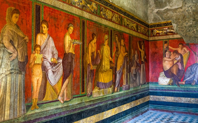 Ancient frescoes depicting figures in the Villa of the Mysteries, Pompeii.
