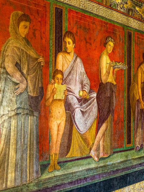 Ancient frescoes depicting figures in the Villa of the Mysteries, Pompeii.
