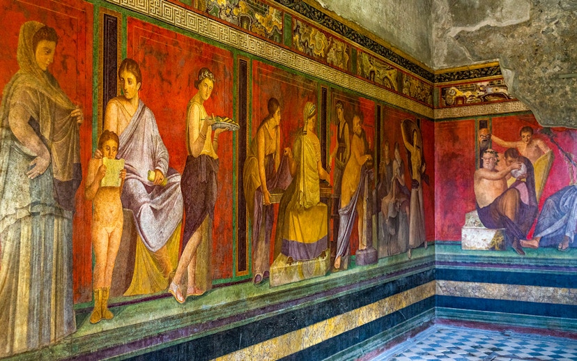 Ancient frescoes depicting figures in the Villa of the Mysteries, Pompeii.