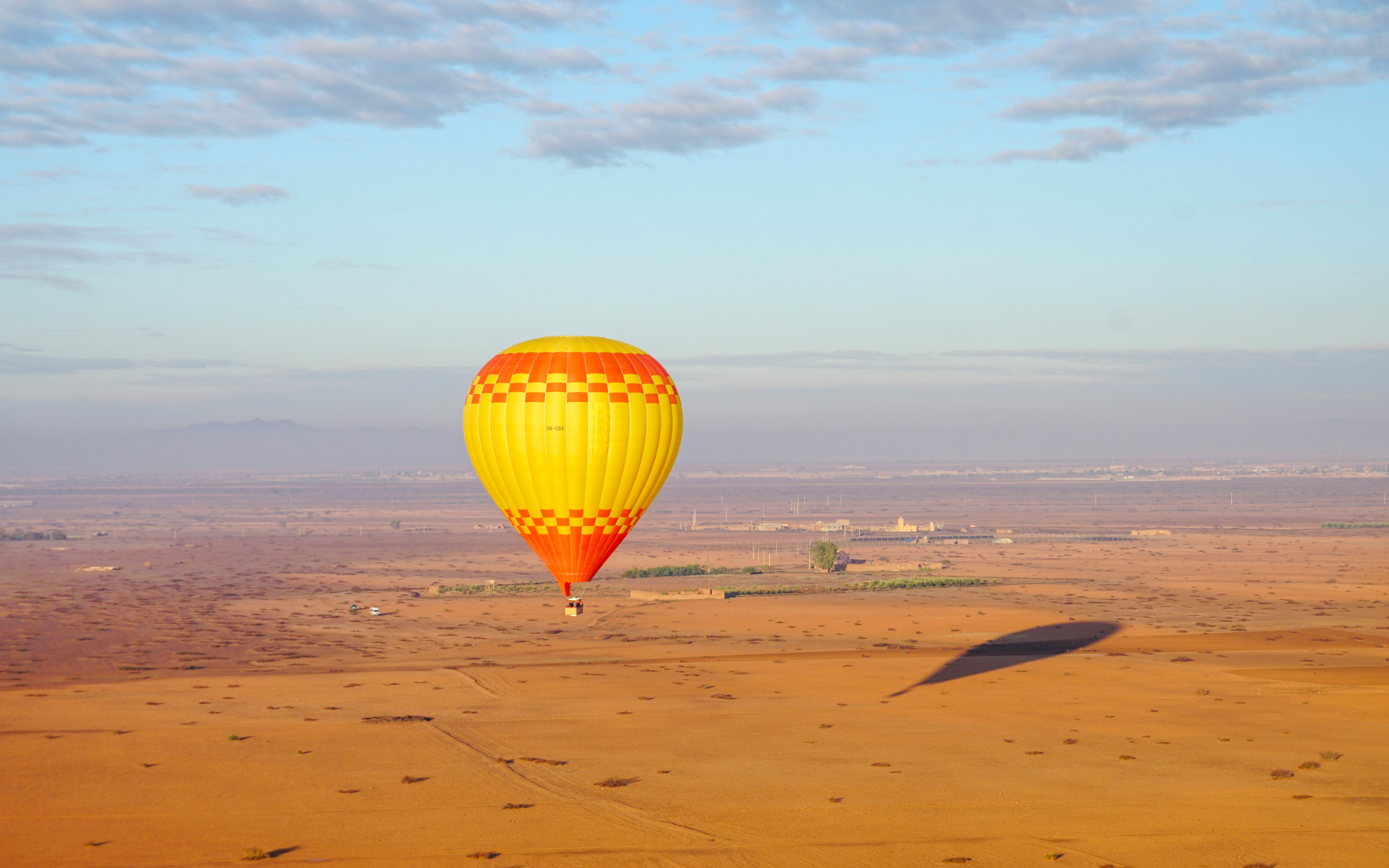 Hot air balloon over Barbar village landscape, Marrakech.