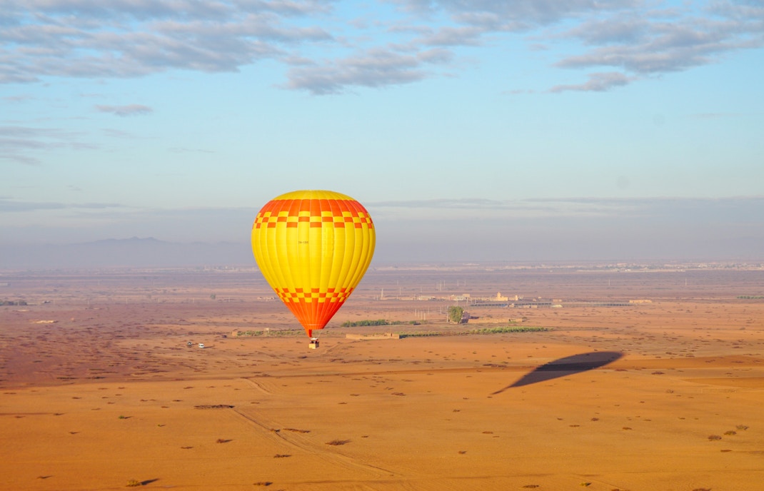 Hot air balloon over Barbar village landscape, Marrakech.