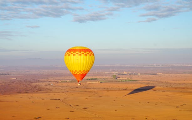 Hot air balloon over Barbar village landscape, Marrakech.