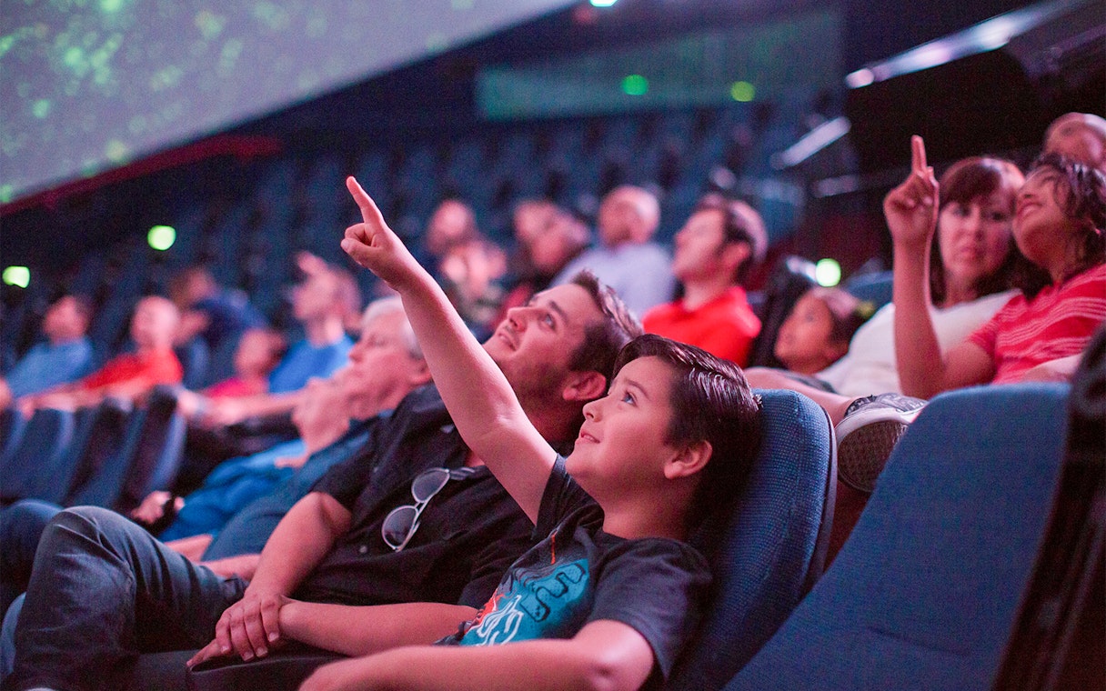 Visitors enjoying a planetarium show in San Diego, part of the Go San Diego Card experience.