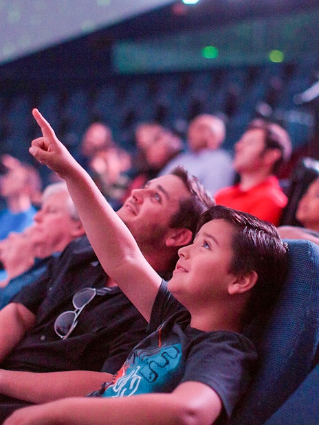 Visitors enjoying a planetarium show in San Diego, part of the Go San Diego Card experience.