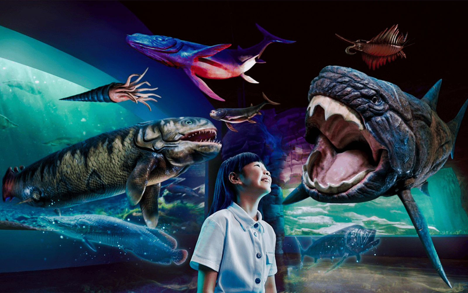 Visitors observing prehistoric sea creatures at Singapore Oceanarium.