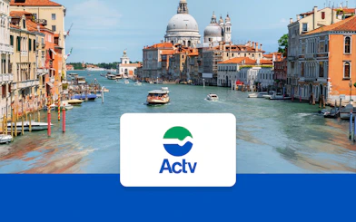 Vaporetto ACTV water bus on Venice's Grand Canal with passengers onboard.