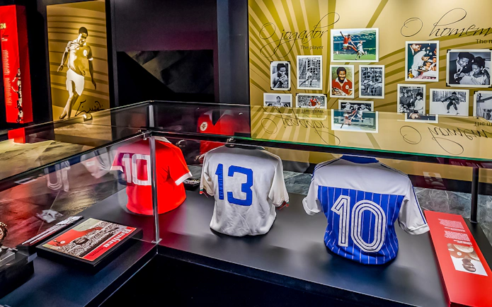 Benfica Museum display with historic football jerseys and player photos.
