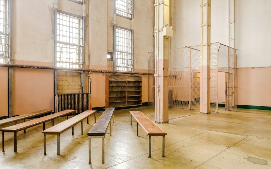 Alcatraz prison interior with benches and barred windows, San Francisco tour.