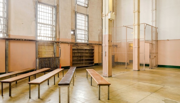 Alcatraz prison interior with benches and barred windows, San Francisco tour.