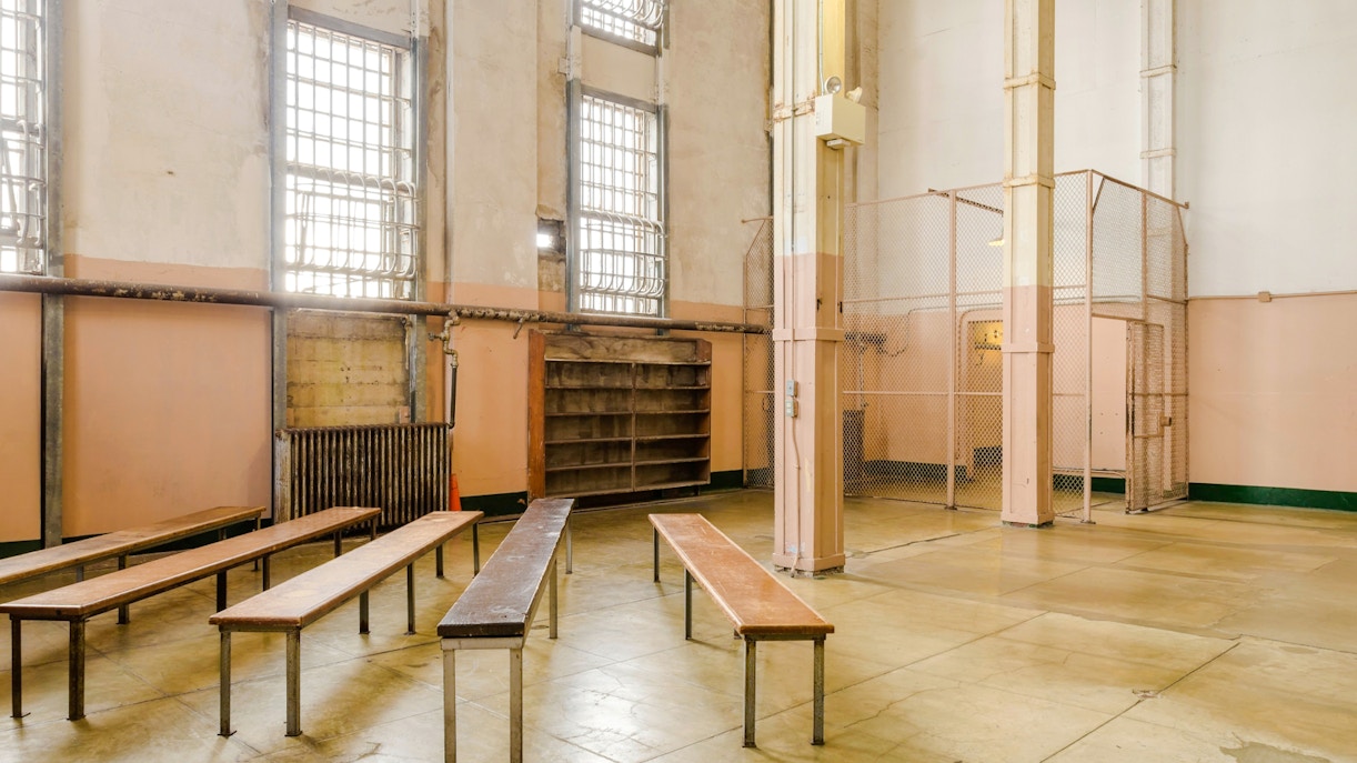 Alcatraz prison interior with benches and barred windows, San Francisco tour.