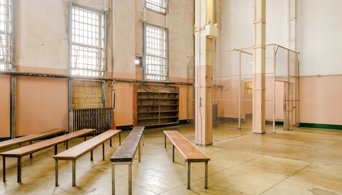 Alcatraz prison interior with benches and barred windows, San Francisco tour.