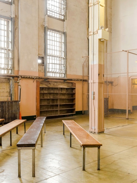 Alcatraz prison interior with benches and barred windows, San Francisco tour.
