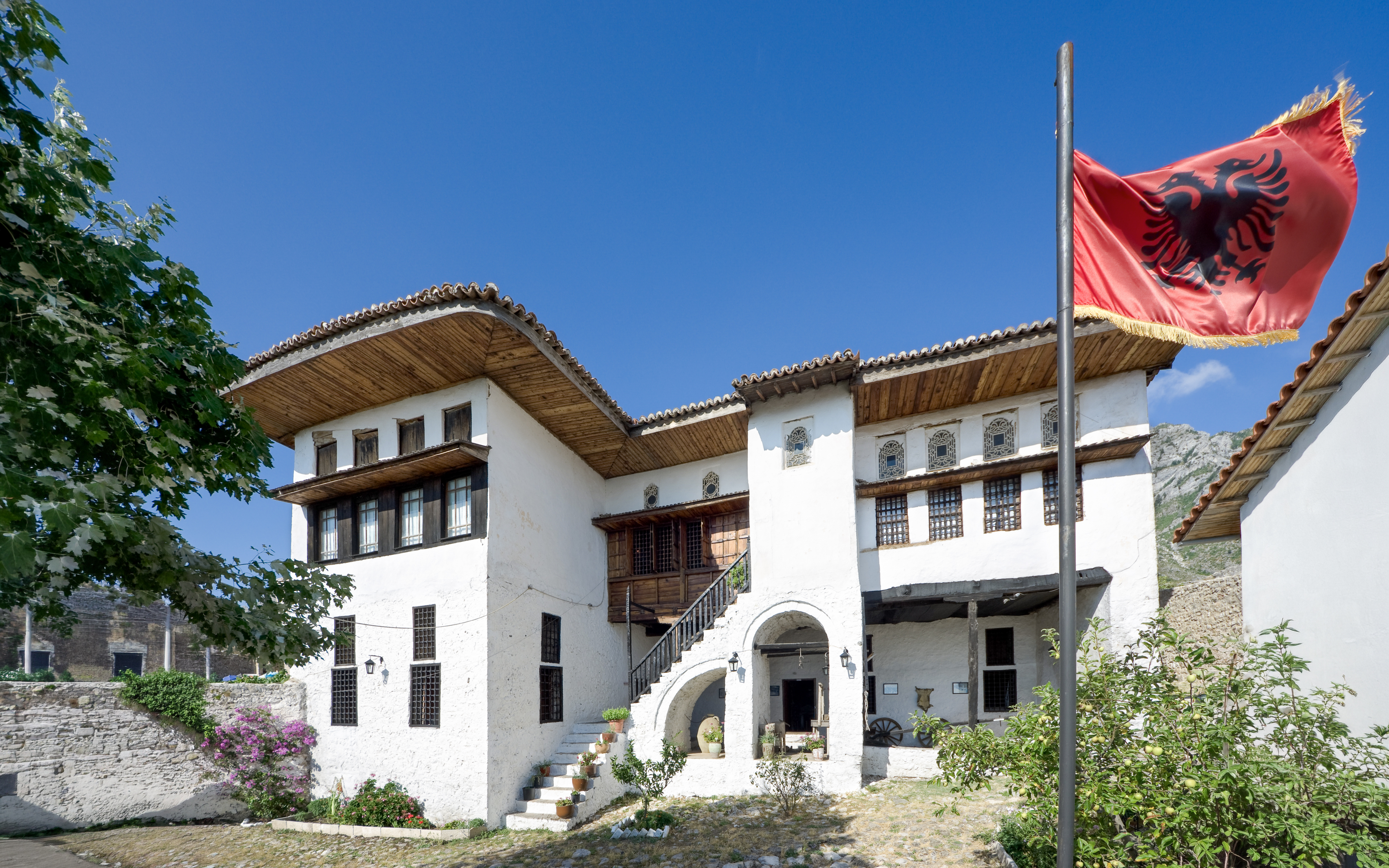 National Ethnographic Museum in Kruja with Albanian flag in foreground.