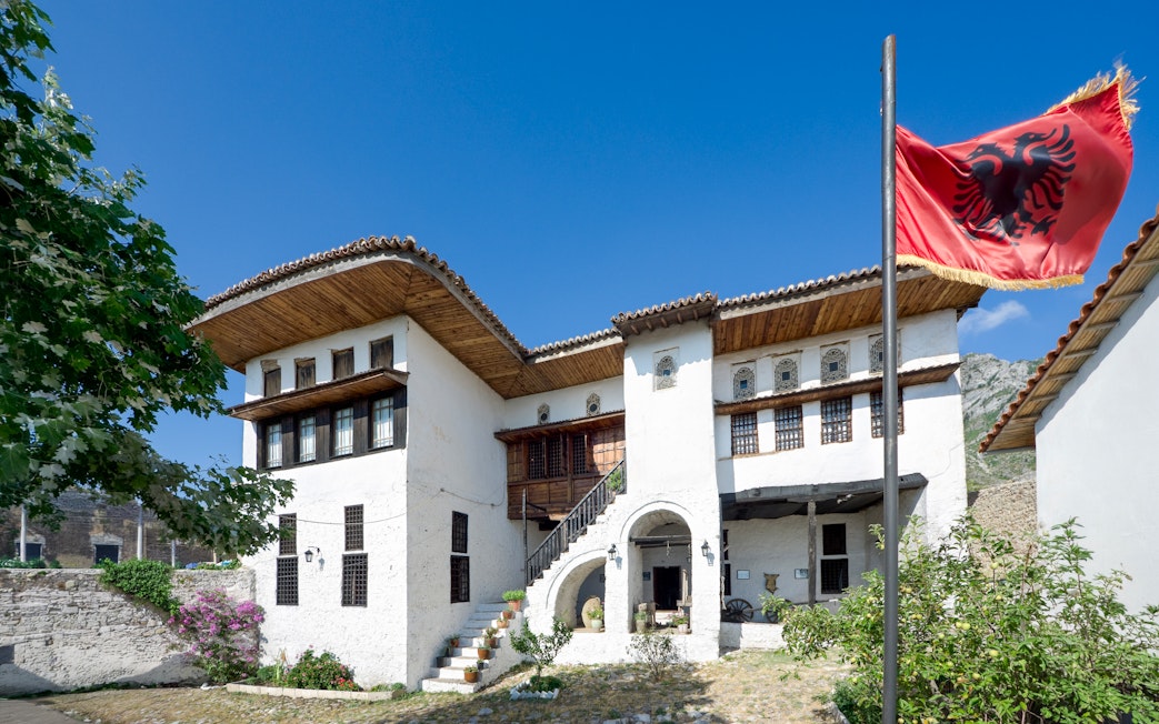 National Ethnographic Museum in Kruja with Albanian flag in foreground.