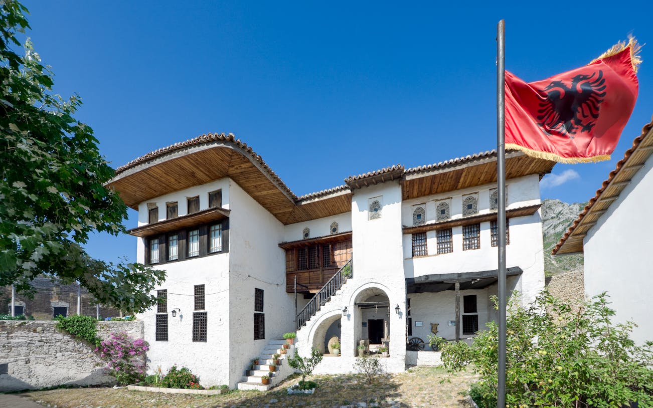 National Ethnographic Museum in Kruja with Albanian flag in foreground.