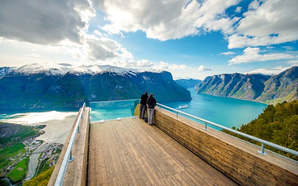 Visitors at Stegastein Viewpoint overlooking Aurlandsfjord in Western Norway.