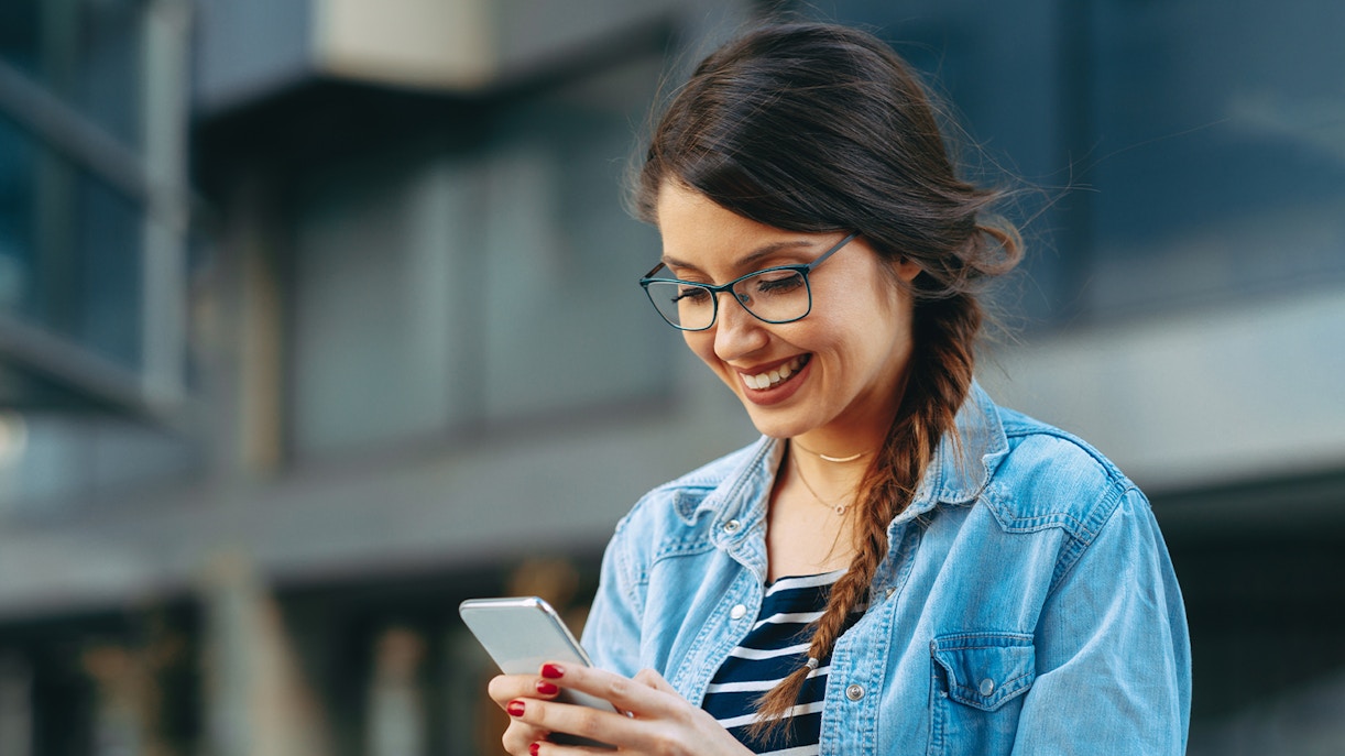 Woman downloading Royal Caribbean app for hassle-free check-in