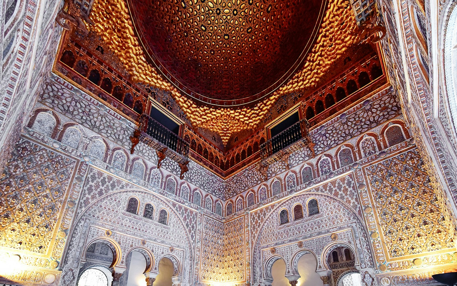 Tourists inside Alcazar of Seville, exploring intricate architecture with Skip-the-Line tickets.