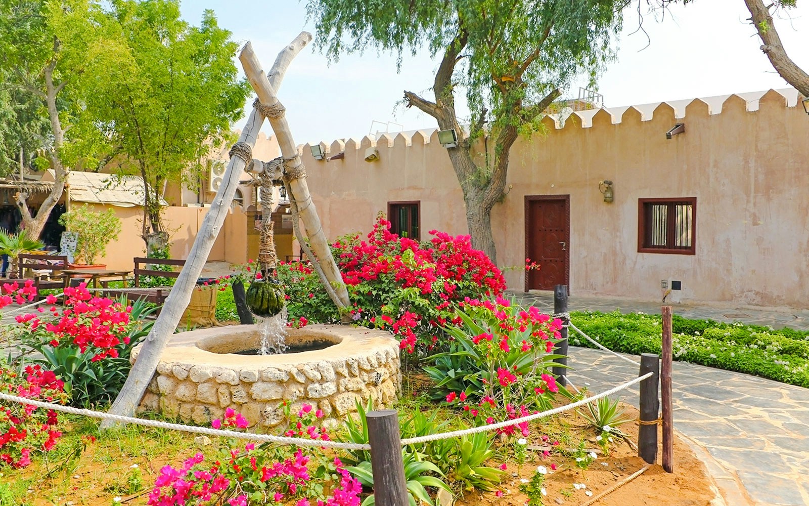 Traditional stone house with well and garden at Heritage Village, Abu Dhabi.