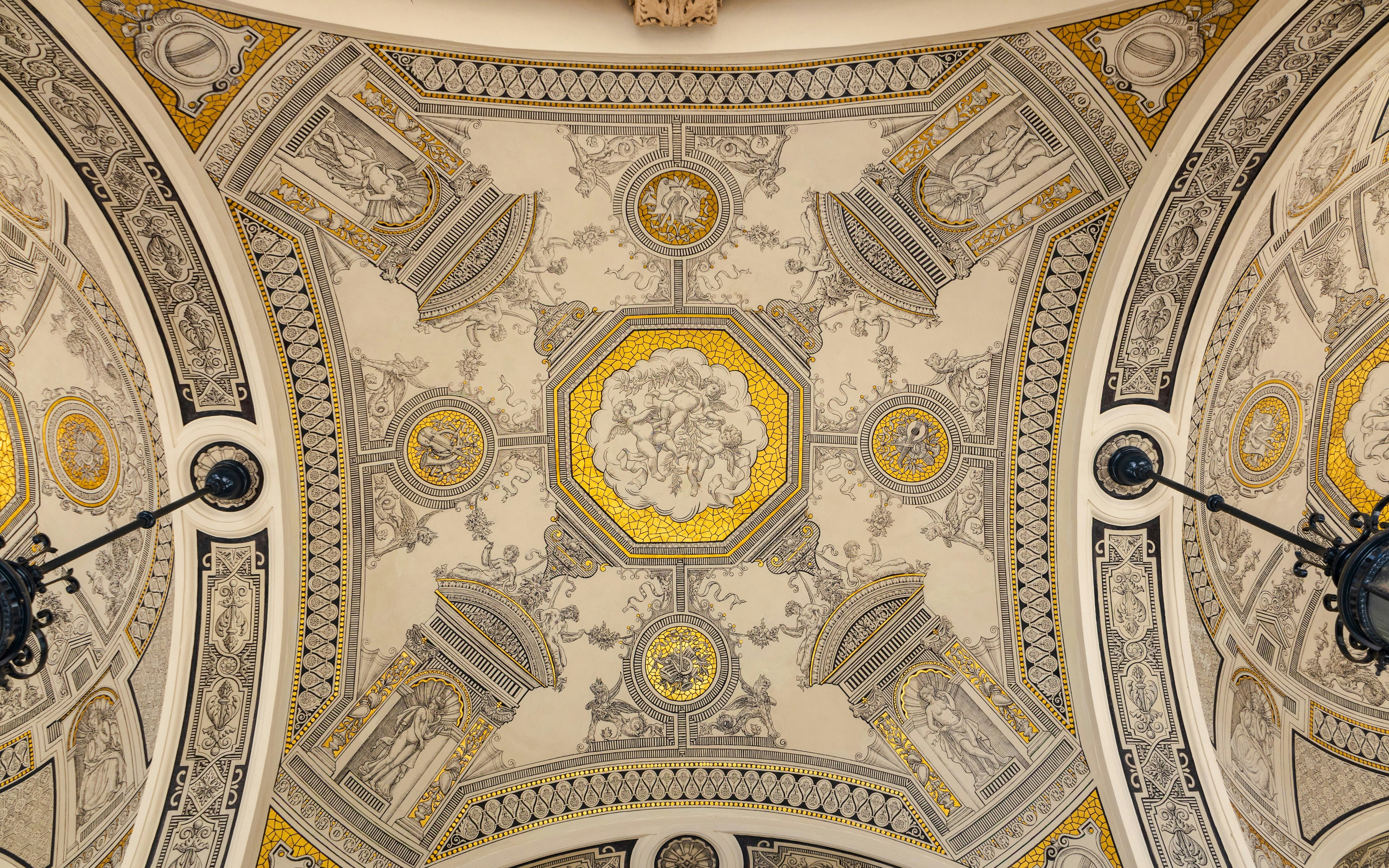 Ceiling frescoes with intricate designs inside Hungarian State Opera.