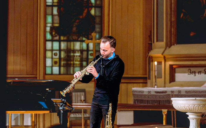 Performer playing saxophone at Midnight Concert in Tromsø Cathedral.