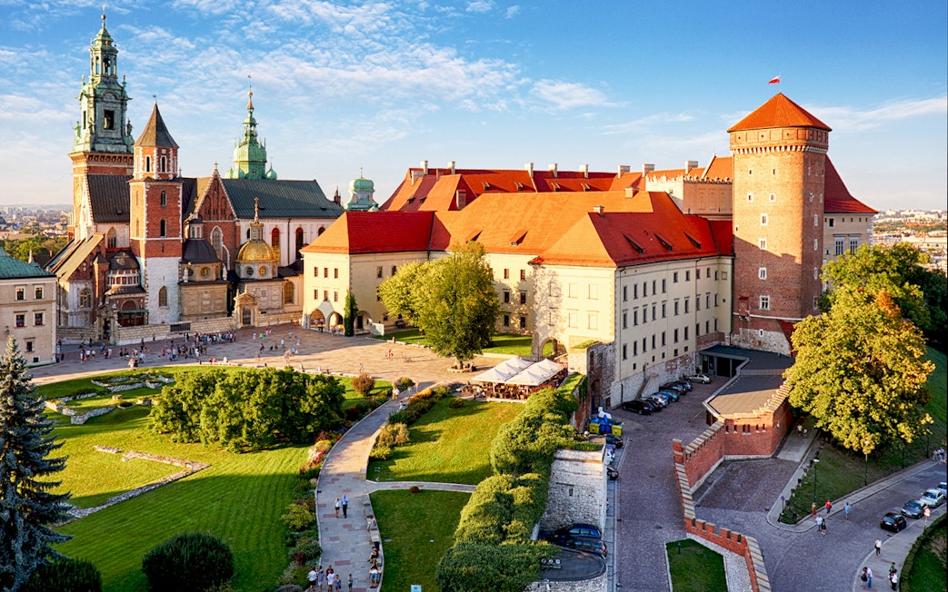 Wawel Castle and Cathedral in Krakow with tourists exploring the grounds.