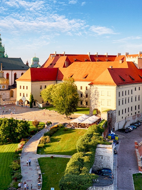 Wawel Castle and Cathedral in Krakow with tourists exploring the grounds.