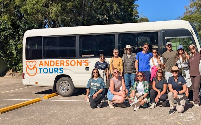 Group of tourists in front of Anderson's Tours bus for Blue Mountains Tour.