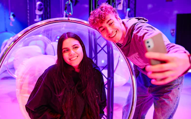 Visitors taking a selfie inside Bubble Planet exhibit, Washington DC.