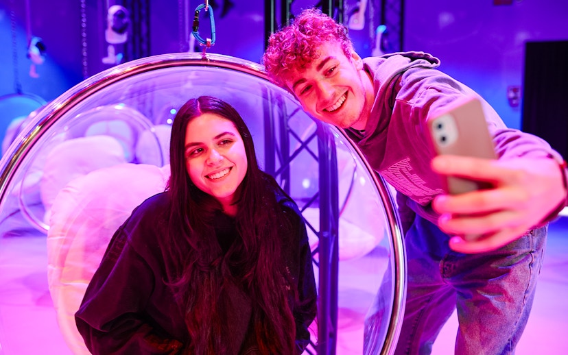 Visitors taking a selfie inside Bubble Planet exhibit, Washington DC.