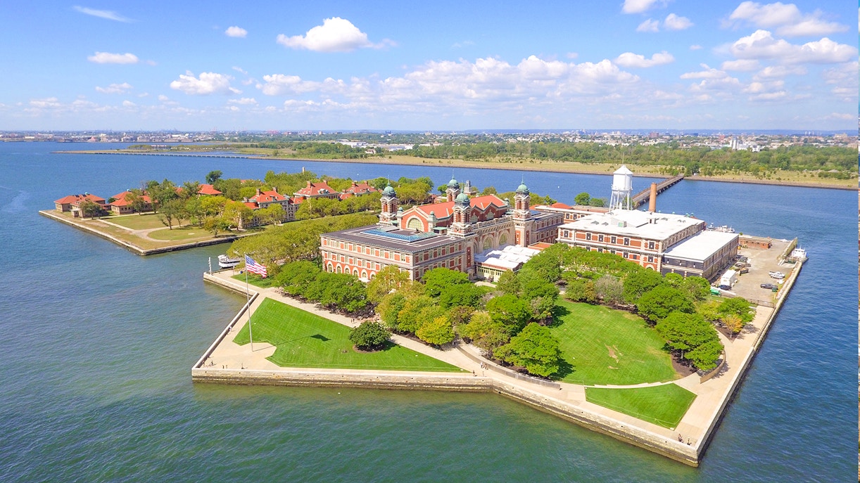 Aerial view of Ellis Island with historic buildings and surrounding water in New York Harbor.