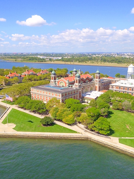 Aerial view of Ellis Island with historic buildings and surrounding water in New York Harbor.