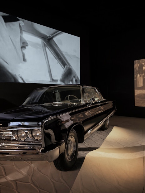 Classic car exhibit with visitors at Zayed National Museum, Abu Dhabi.