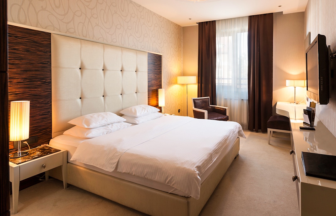 Hotel room interior with a view of London Zoo in the background.