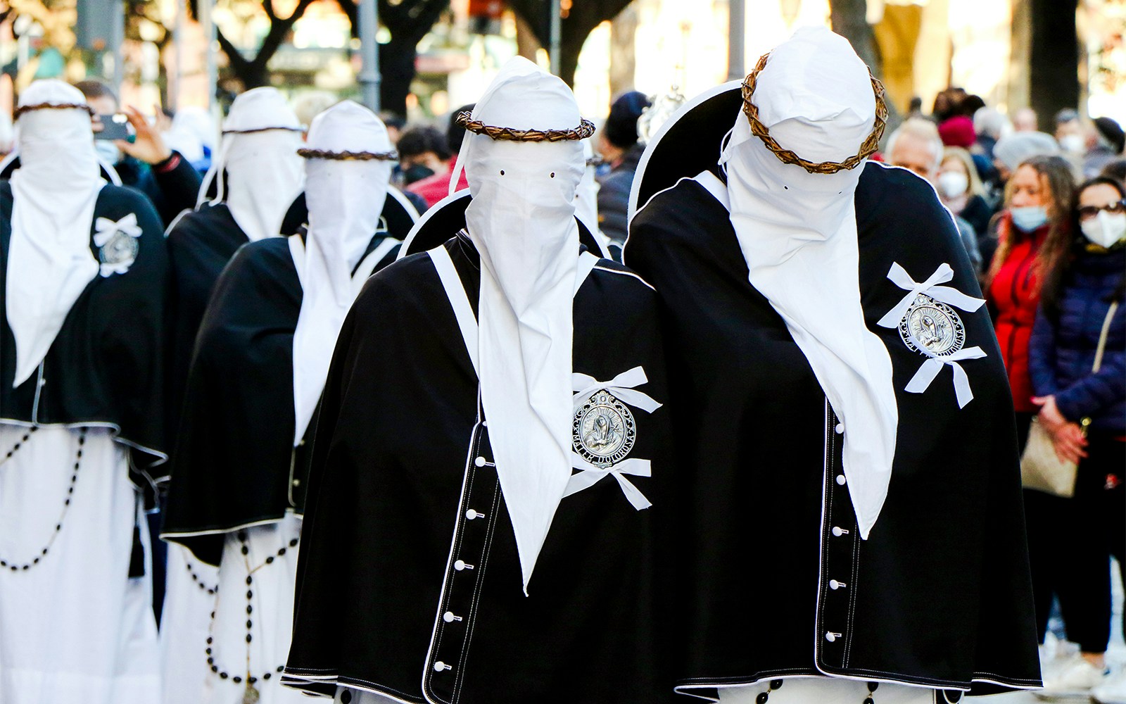 Procession of the Mysteries in Naples, Italy with participants in traditional attire.