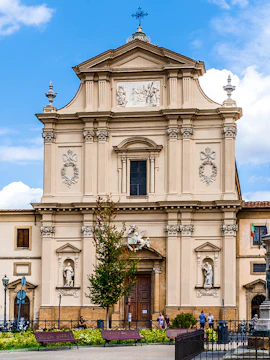 Facade of San Marco Church in Florence, Italy, with detailed sculptures and architectural elements.