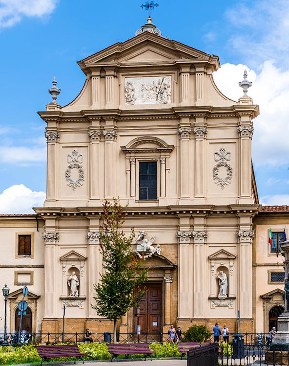 Facade of San Marco Church in Florence, Italy, with detailed sculptures and architectural elements.