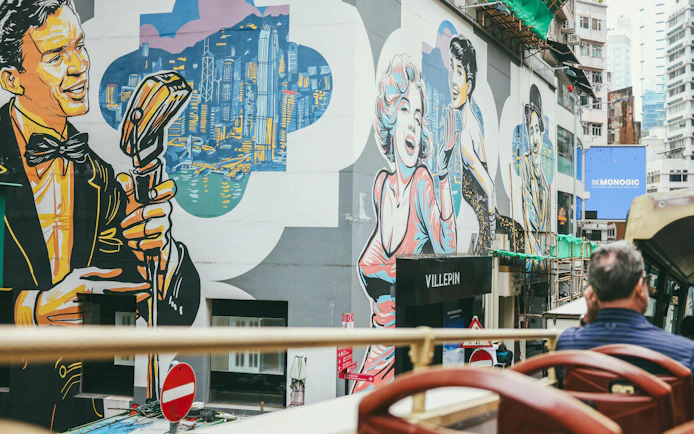 Street art murals viewed from a Hong Kong hop-on hop-off bus tour.