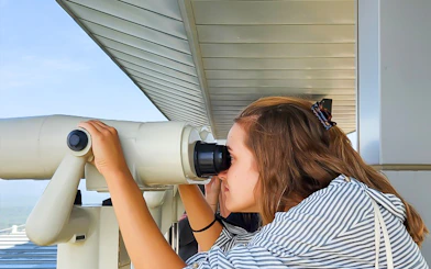 Person using binoculars at Korean Demilitarized Zone observation deck.