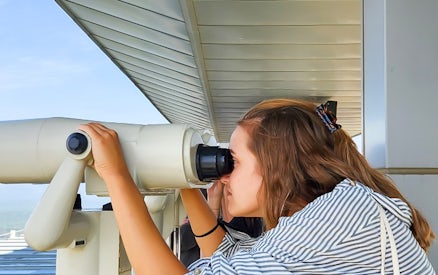 Person using binoculars at Korean Demilitarized Zone observation deck.