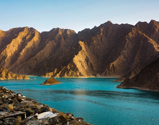 Hatta Dam Lake with turquoise waters surrounded by rugged mountains in eastern Dubai, UAE.