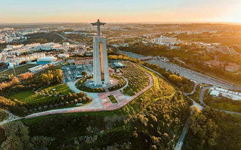Christ the King statue overlooking Lisbon, part of Arrábida & Sesimbra wine tour experience.