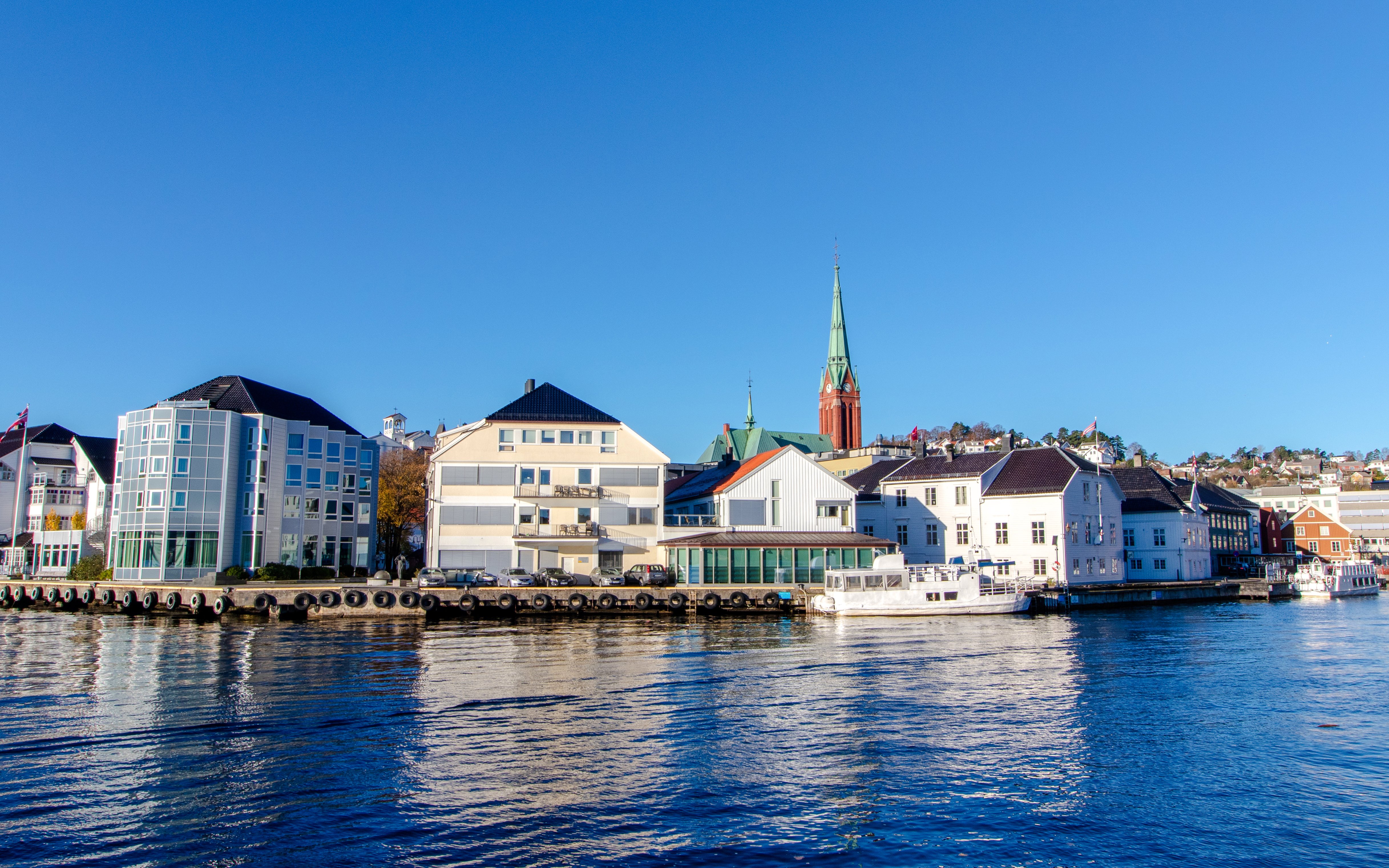 Colorful waterfront buildings and a church spire in Gamla Stan, Stockholm.