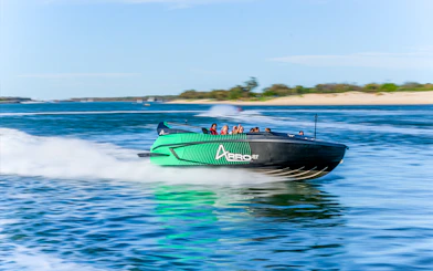 Arro Jet Boat speeding on the Gold Coast waters with passengers.