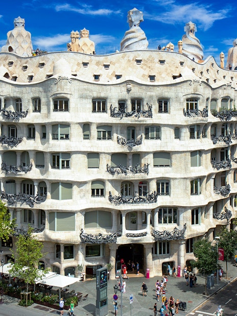 La Pedrera-Casa Milà in Barcelona, view of the unique facade and rooftop sculptures.